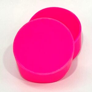 A pair of pink round shaped plastic containers.