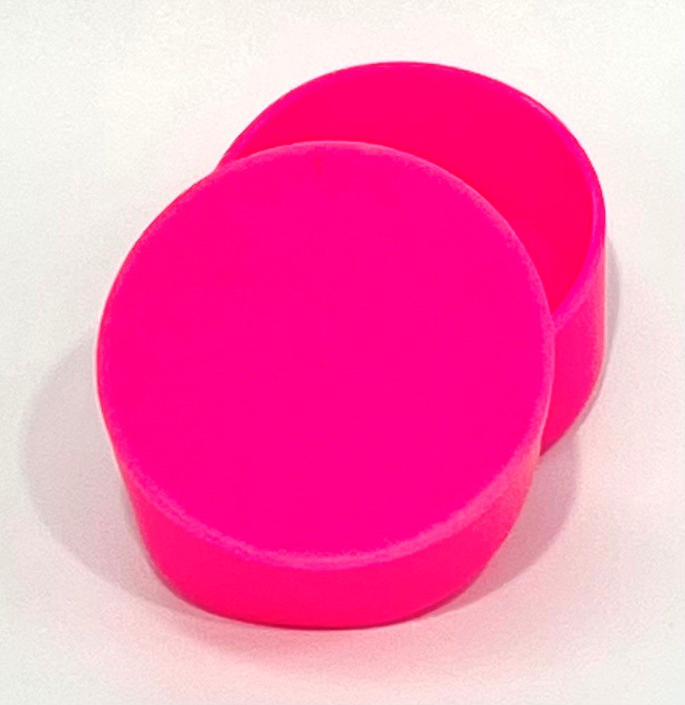 A pair of pink round shaped plastic containers.