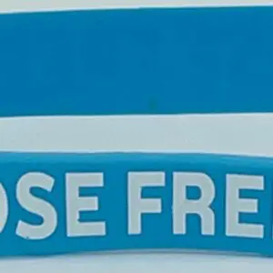 A close up of the words " lose free " on a blue wristband.