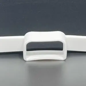 White plastic buckle on dark background.