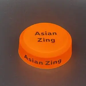 Orange puck with "Asian Zing" text.