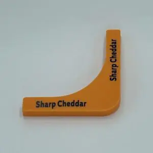 Orange "Sharp Cheddar" cheese label on white.