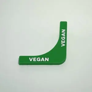 Green vegan label on white background.