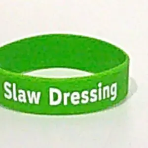 Green wristband with "Slaw Dressing" text.