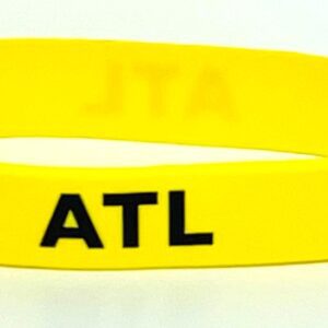 Yellow wristband with "ATL" in black.