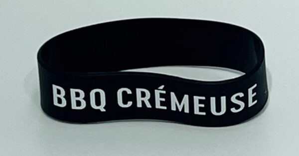 A black and white wristband with the words bbq crêmeur written on it.