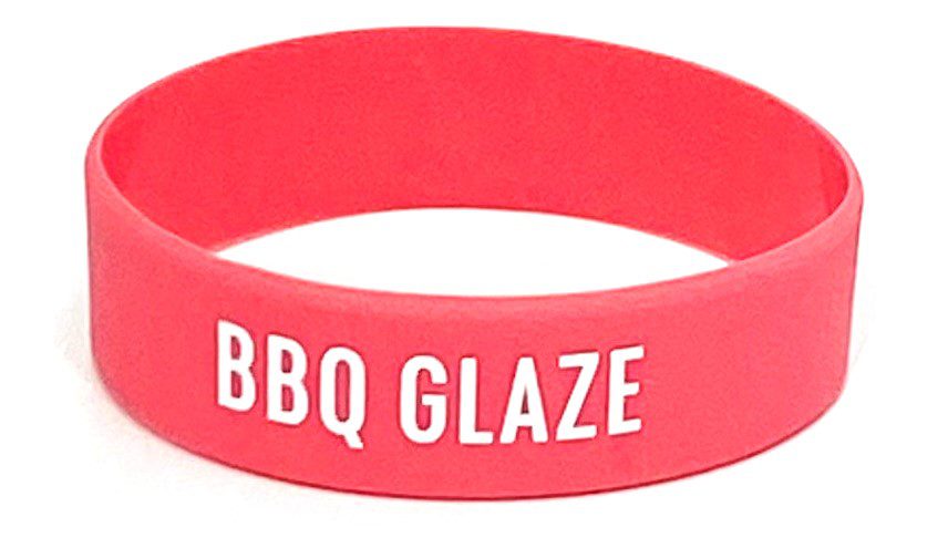 A red wristband with the words bbq glaze written on it.