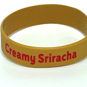 Yellow wristband with "Creamy Sriracha" text.