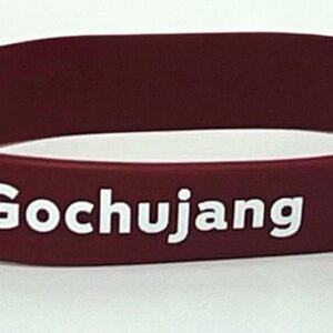 Red wristband with "Gochujang" text.