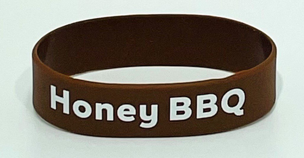 A brown bracelet with the words honey bbq written on it.