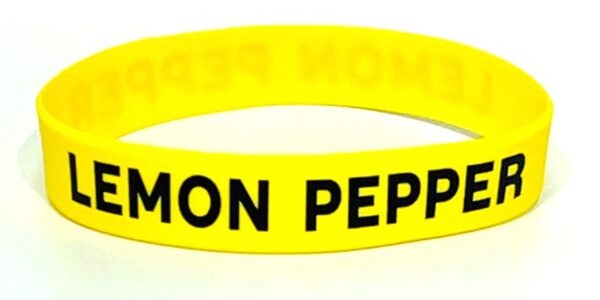 A yellow rubber bracelet with the words " lemon pepper ".