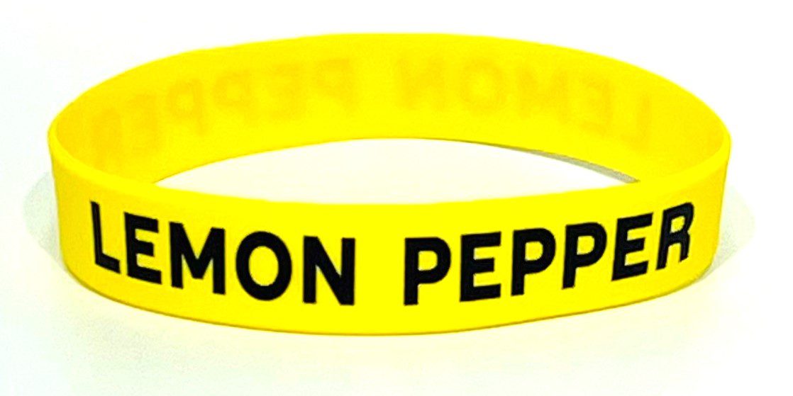 A yellow rubber bracelet with the words " lemon pepper ".