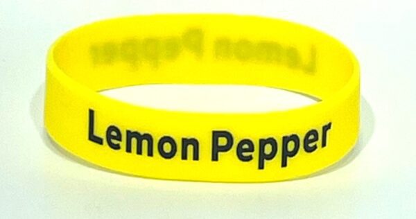 A yellow rubber bracelet with the words " lemon pepper ".