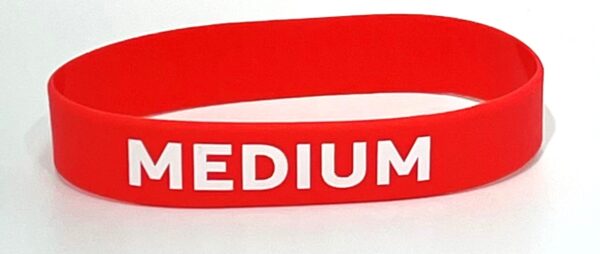 A red wristband with the word medium written on it.