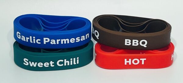 Four different colored bracelets with the names of various foods.