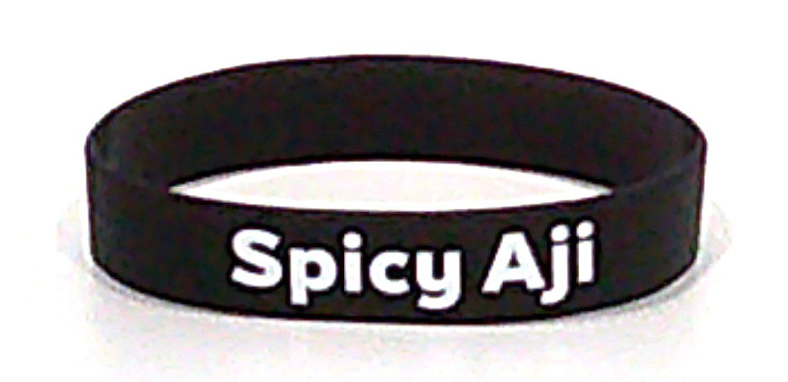 A black bracelet with the words spicy ajaira on it.