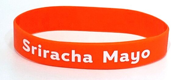 A close up of the orange bracelet with white lettering