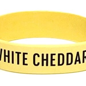 A yellow wristband with the words " white cheddar " written on it.