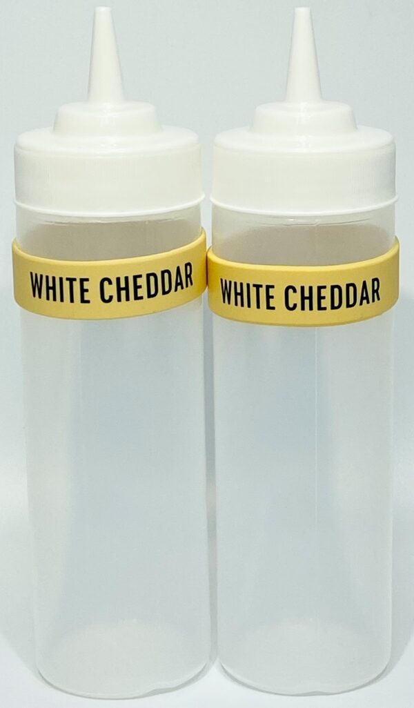 Two white cheddar bottles with yellow caps.