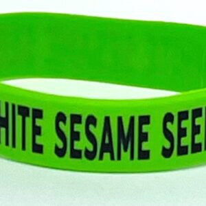 A green wristband with the words " white sesame seeds ".
