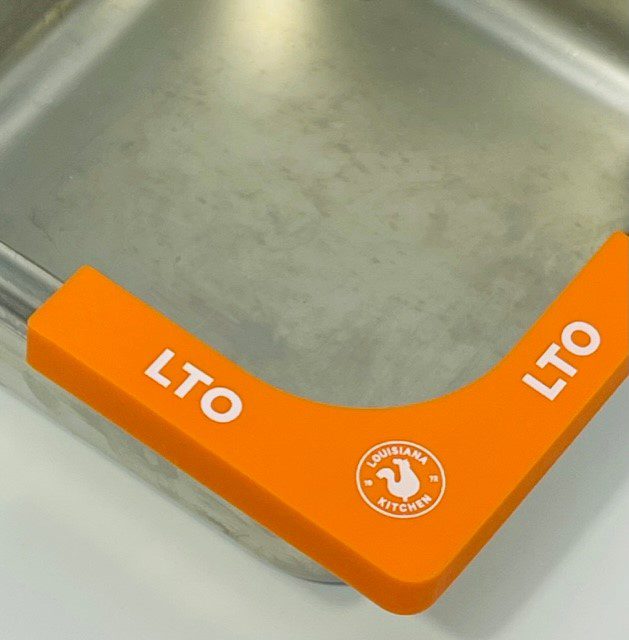 A close up of an orange handle on a metal box