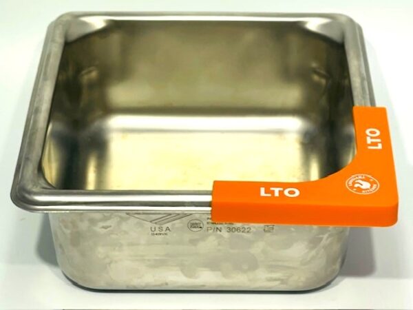 A metal pan with orange tags on it.