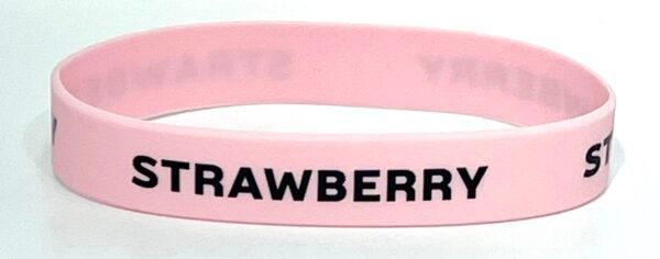 A pink bracelet with the word strawberry written on it.