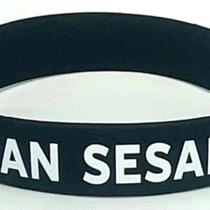 A black and white wristband with the words " i am sesan ".