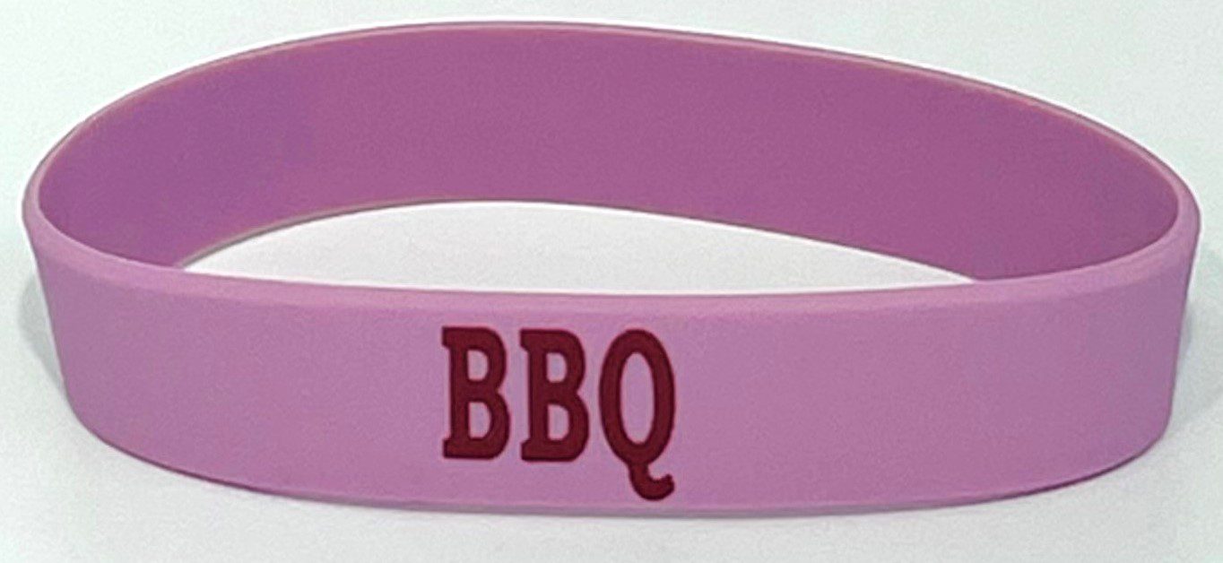 A pink wristband with the word bbq written on it.