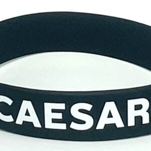 A black wristband with the word caesar written on it.