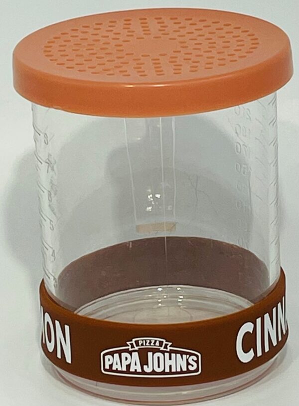 A container with a lid and a spice shaker.