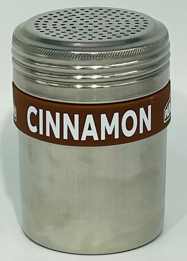 A metal container with cinnamon on top of it.