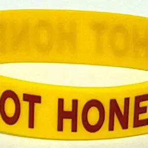 A yellow wristband with the words " hot honey ".