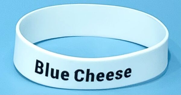 A white bracelet with the words blue cheese on it.