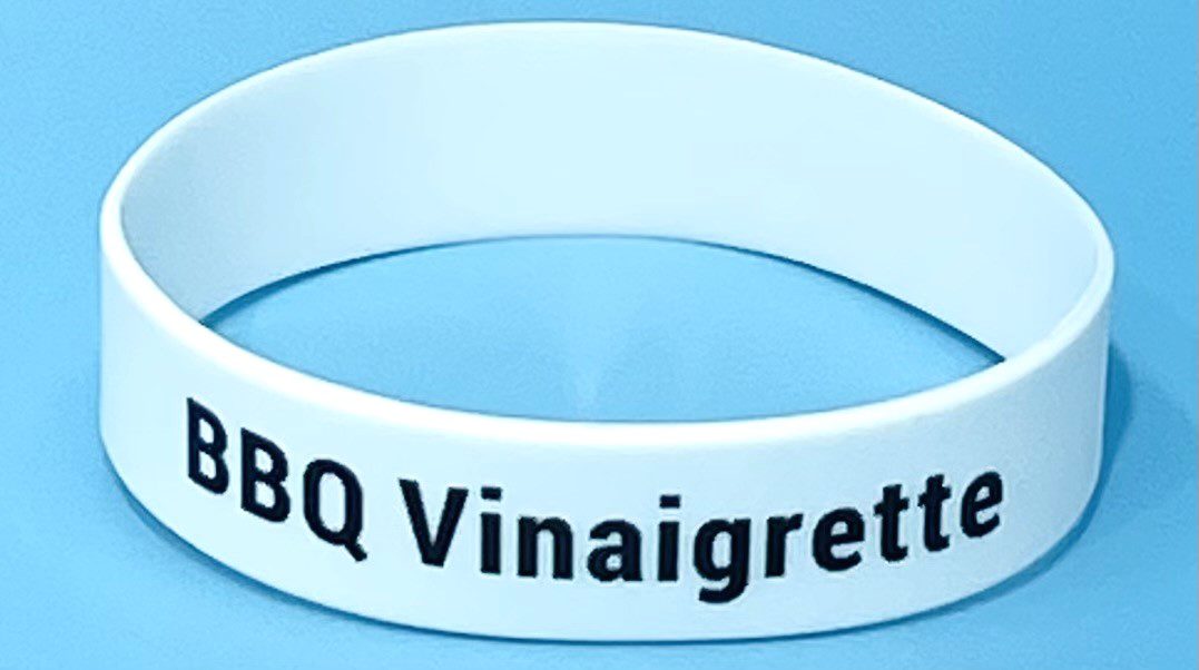 A white bracelet with the words bbq vinaigrette on it.