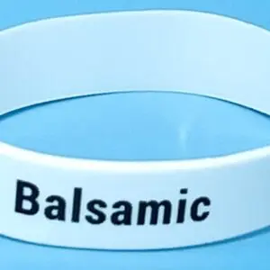 A white bracelet with the word balsamic written on it.