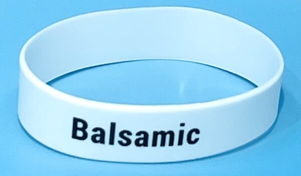 A white bracelet with the word balsamic written on it.