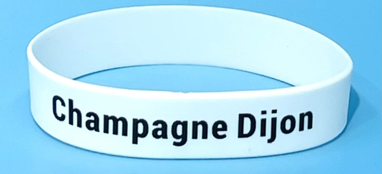 A white bracelet with the words " champagne dijon ".