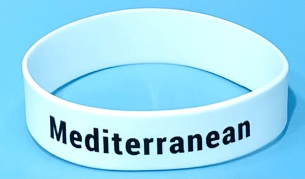 A white wristband with the word mediterranea written on it.