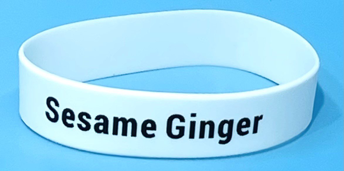 A white wristband with the same ginger name on it.