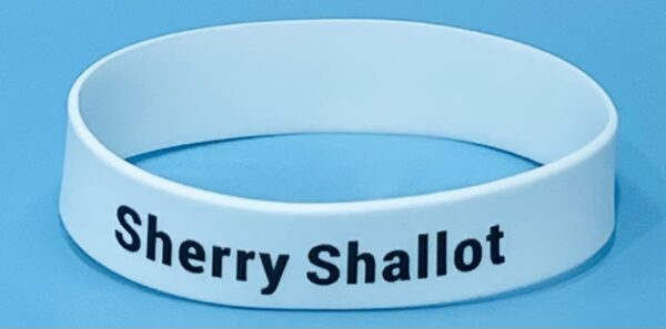 A white bracelet with the words " cherry shallotte ".