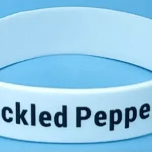 A white bracelet with the words " tickled pepper ".