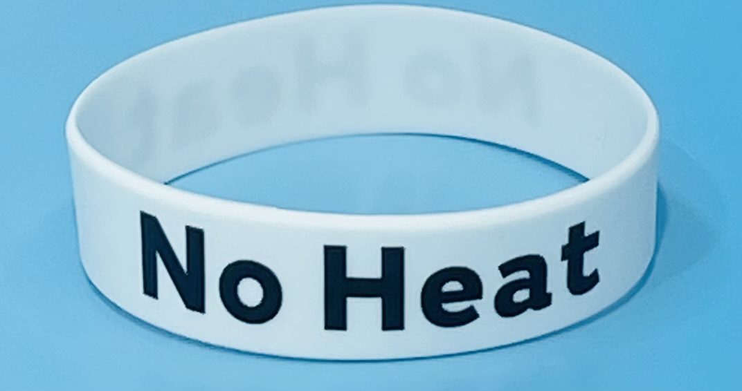 A white bracelet with the words " no heat ".