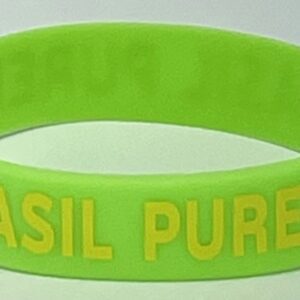 A green bracelet with the words " basil pure " written on it.