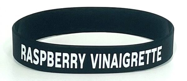 A black and white wristband with the words berry vinaigar written on it.