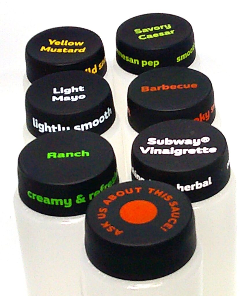 A group of eight hockey pucks with different colors.