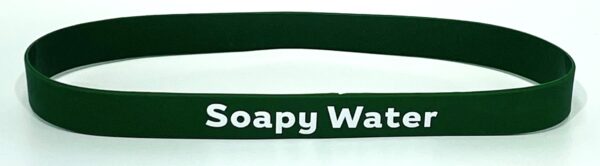 A green rubber bracelet with the words soapy water on it.