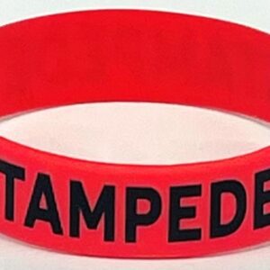 A red rubber bracelet with the word " stampede ".