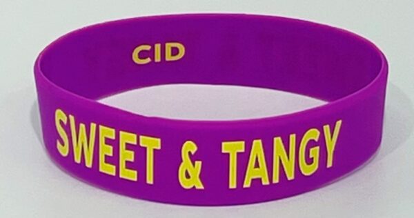 A purple bracelet with the words " sweet & tangy ".