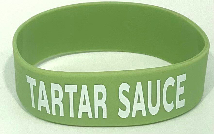 A green bracelet with the words " sartar sauced ".